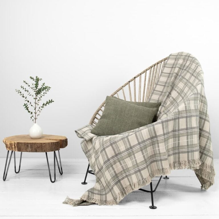 Beige checked linen cotton blanket full view with side table and chair