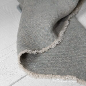 linen grey blue blanket with fringes around.