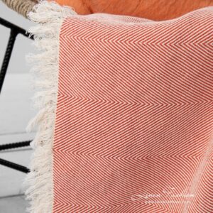 Linen cotton orange blanket with fringes.
