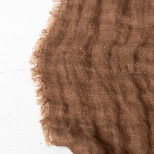 brown linen bedspread, with fringes around