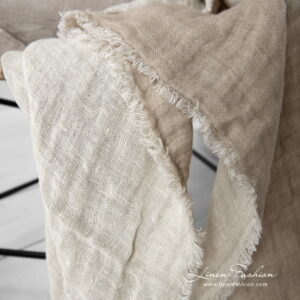 Linen double side beige blanket with fringes around.