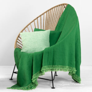 linen green throw with cushions.