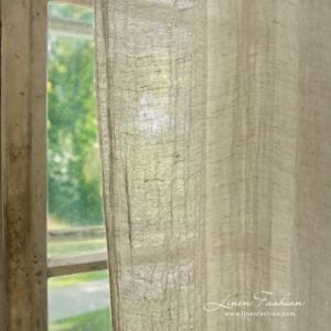 Light grey coloured 100% linen curtain.
