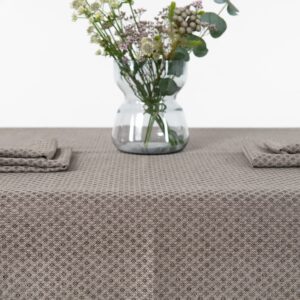 Brown tablecloth linen cotton, diamond pattern, with flower vase