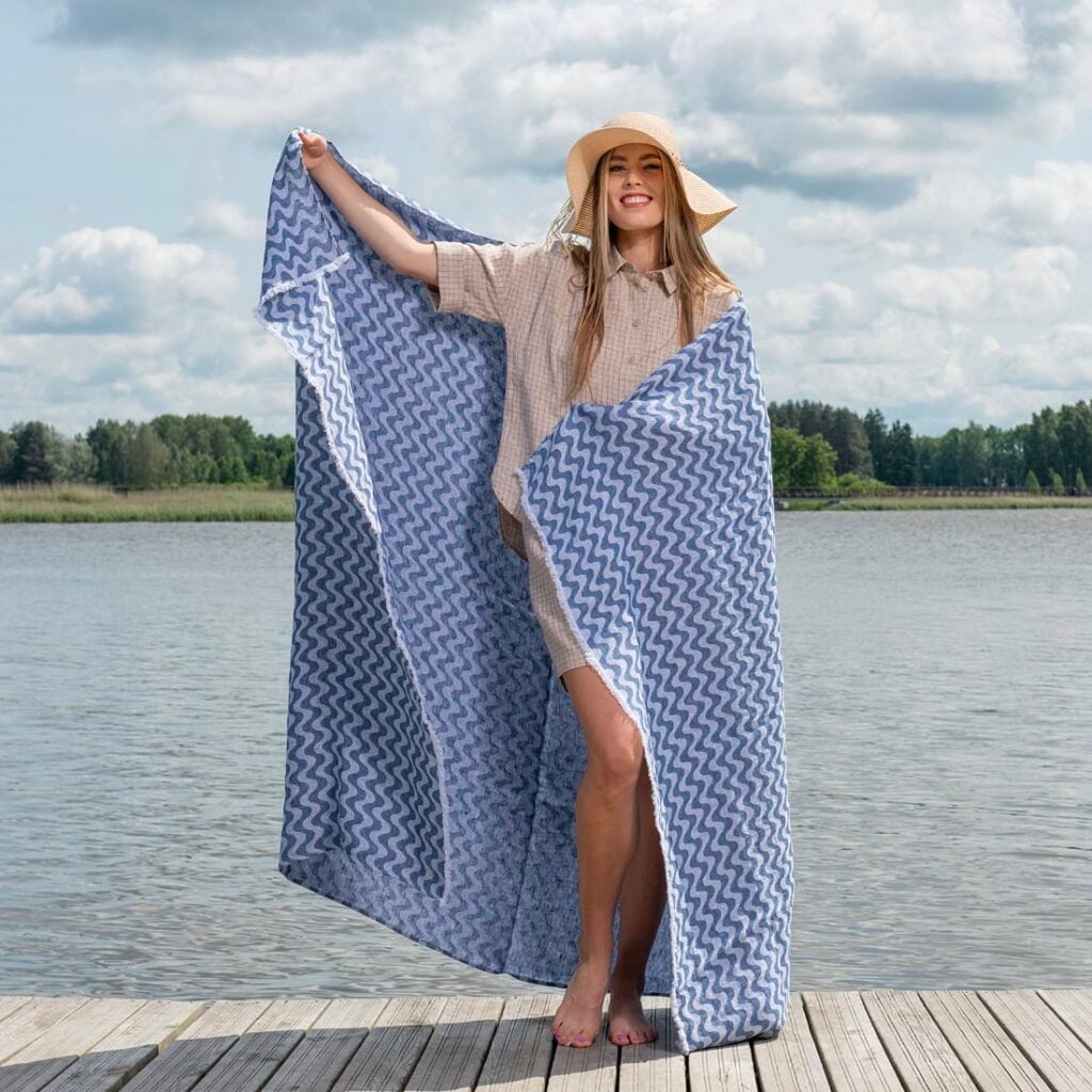 Linen beach towel in blue and white wavy stripes