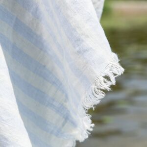 Linen beach towel in yellow and blue stripes, with fringe