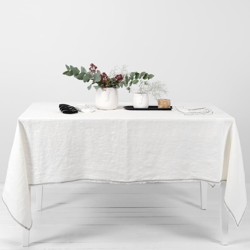 white linen tablecloth with decorative seam.