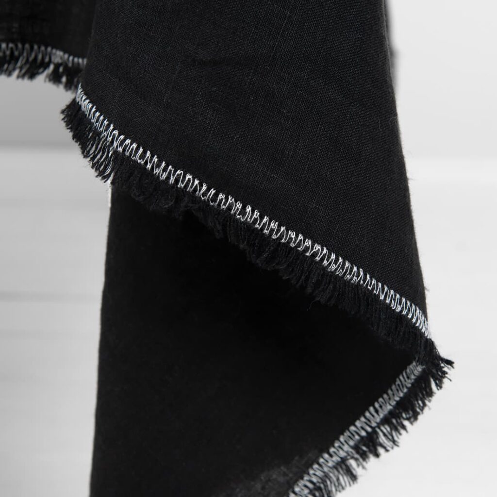 ALBA Duk svart 4 linen black tablecloth with decorative seam in white.