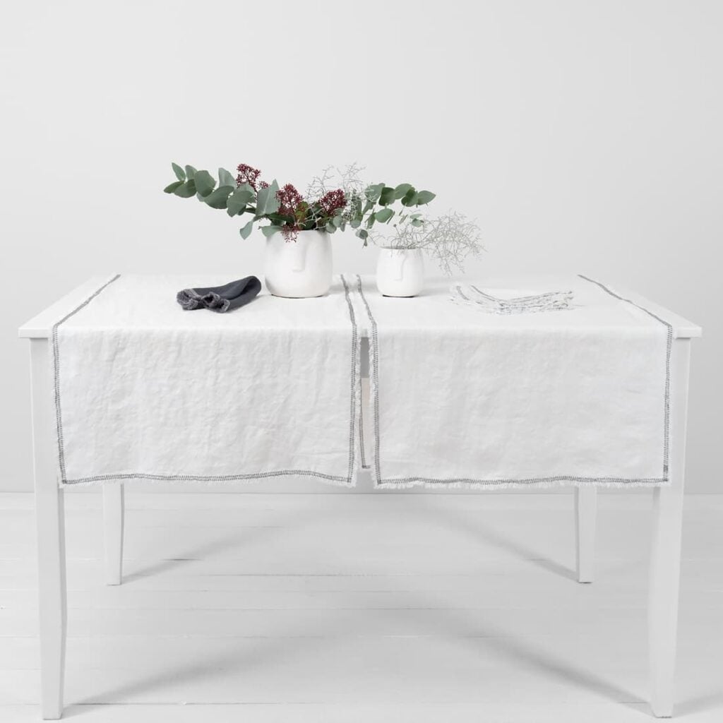 white linen runner with decorative stitch