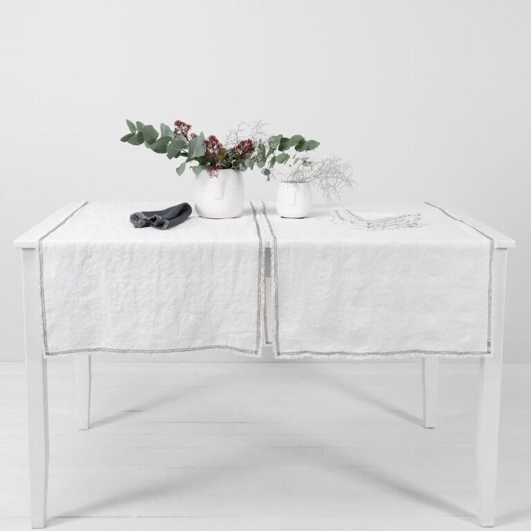 white linen runner with decorative stitch