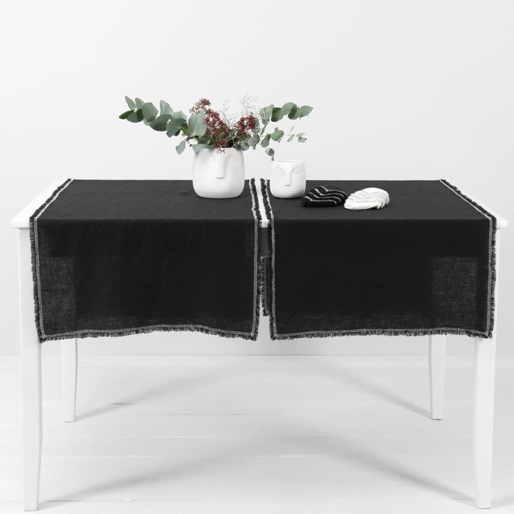 black linen runner with decorative stitch
