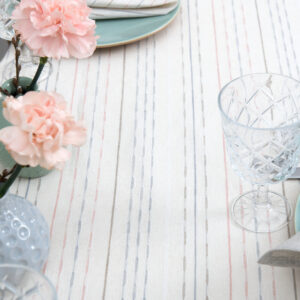 White linen cotton round tablecloth with colourful dashed stripes, multiple colour stripes