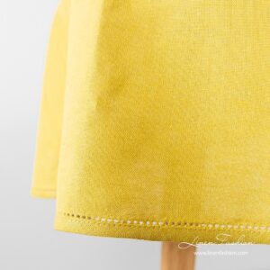 Oval tablecloth, luna, in yellow color.