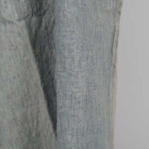 Linen washed fabric grayish blue color for sewing clothes and home textiles close edge view