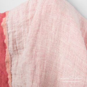 Fabric side woven from white and creamy yarns with rose dots