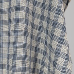 Washed cream colour linen fabric in checks.