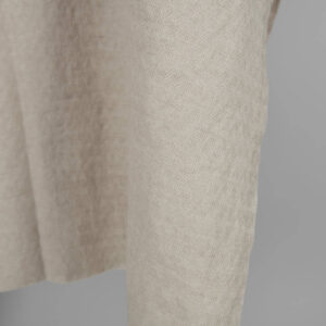 Washed linen cotton sand colour herringbone pattern close up edge view