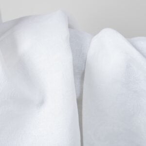 Optical white linen cotton fabric with flower ornaments texture