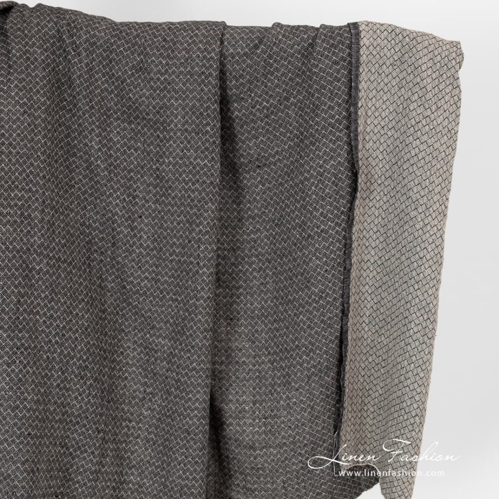 Washed linen fabric in small black grey diamond pattern.