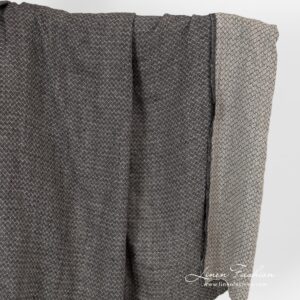Washed linen fabric in small black grey diamond pattern.