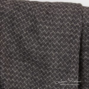 100% washed linen fabric in small black grey diamond pattern.