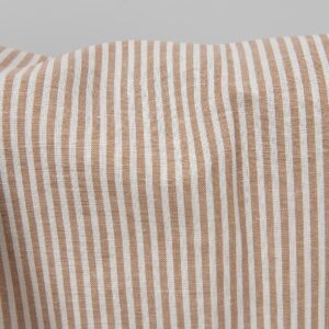 Wide linen cotton fabric in white and brown stripes close up detail