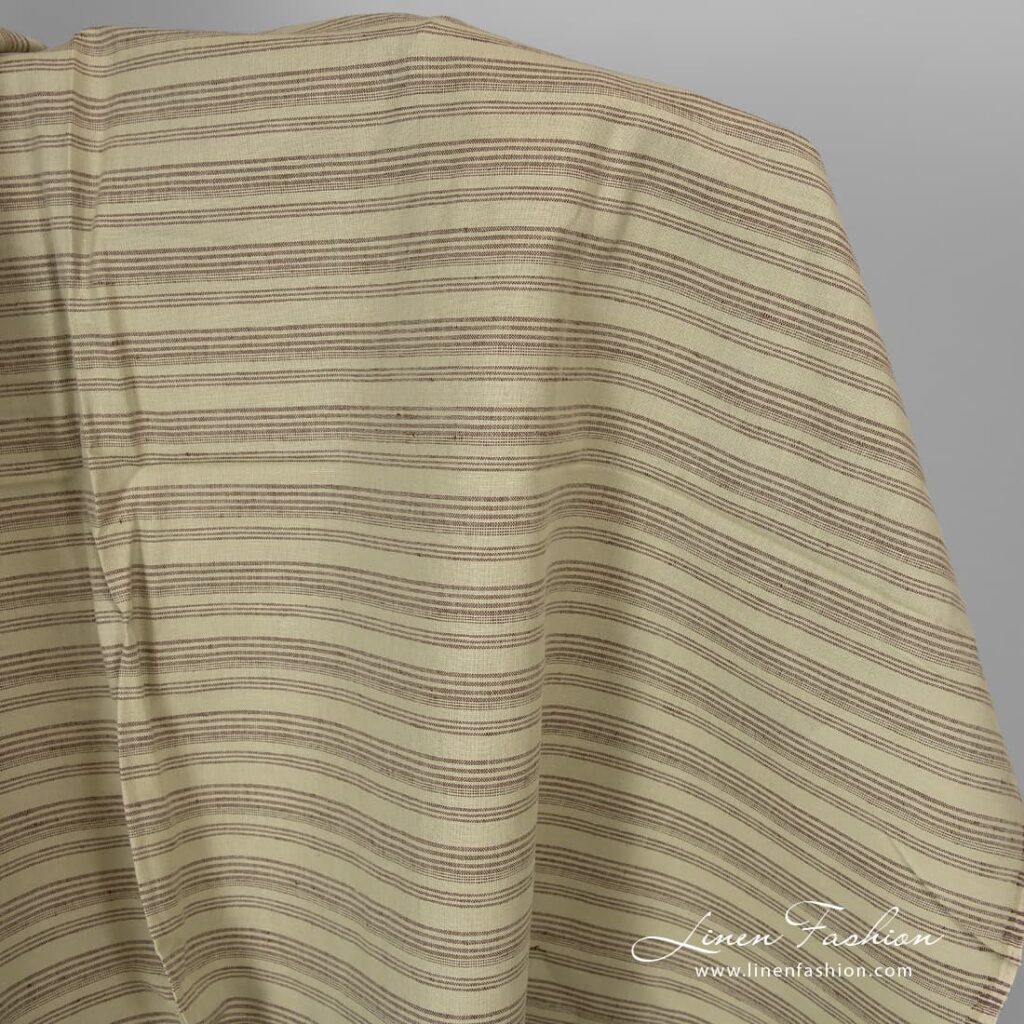 Pale green linen cotton fabric with brown stripes.