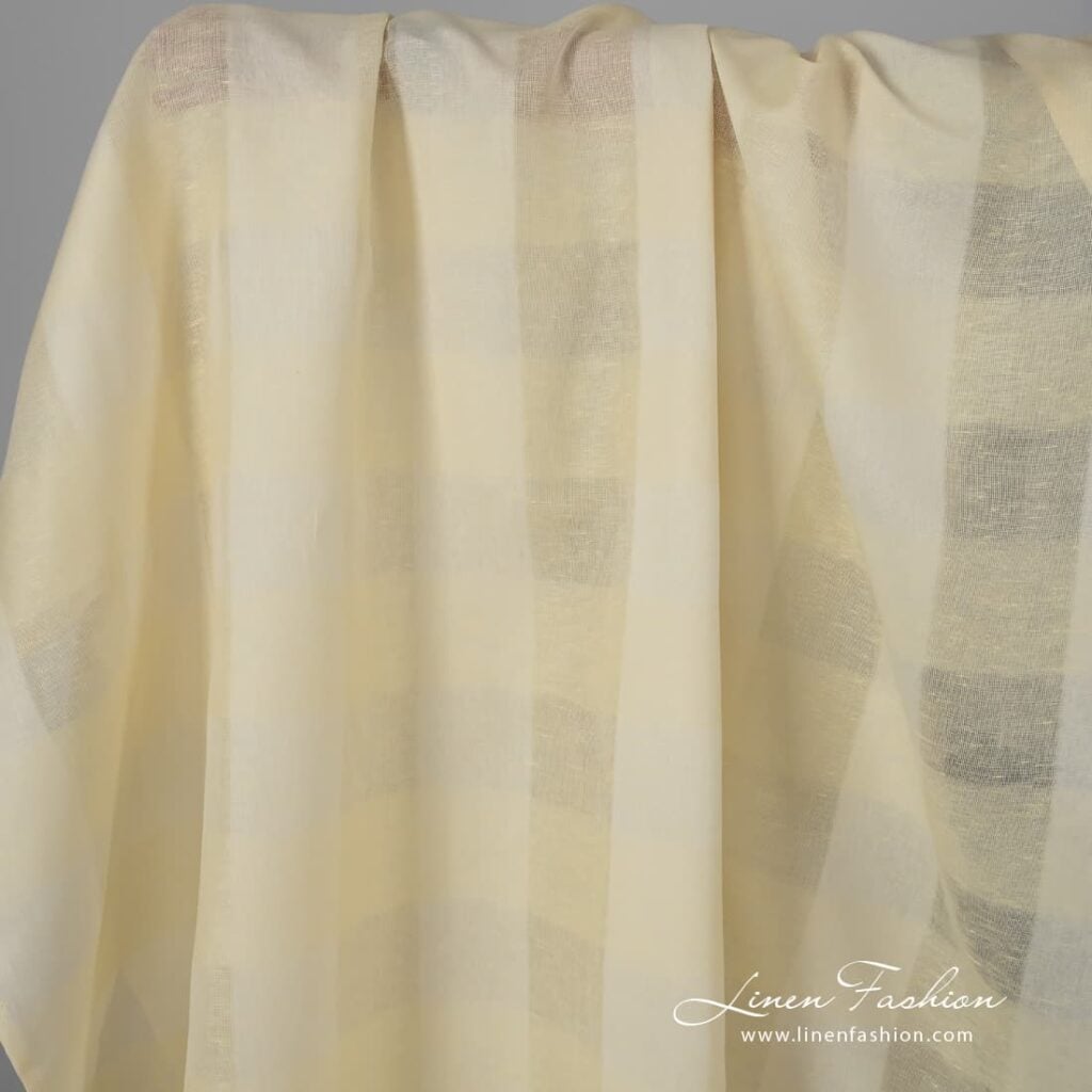 Pale yellow linen cotton fabric with stripes.