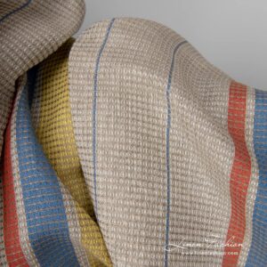 Linen cotton fabric sand waffle with yellow red stripes close up detail