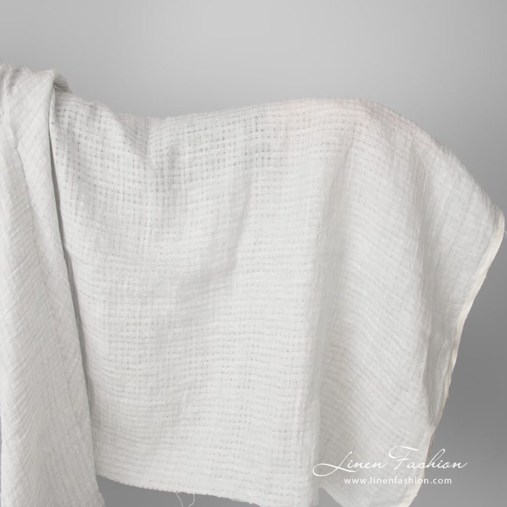 Light grey openwork linen fabric, washed
