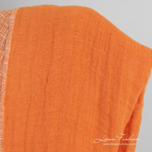 Double-sided orange linen fabric in checks, perfect for clothes and home textile