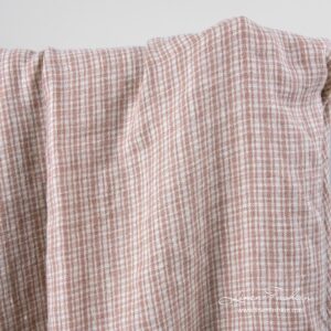 Lin-ullstoff med brune ruter vasket