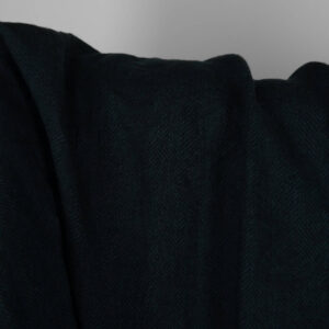 Washed linen wool fabric black in herringbone pattern close up detail