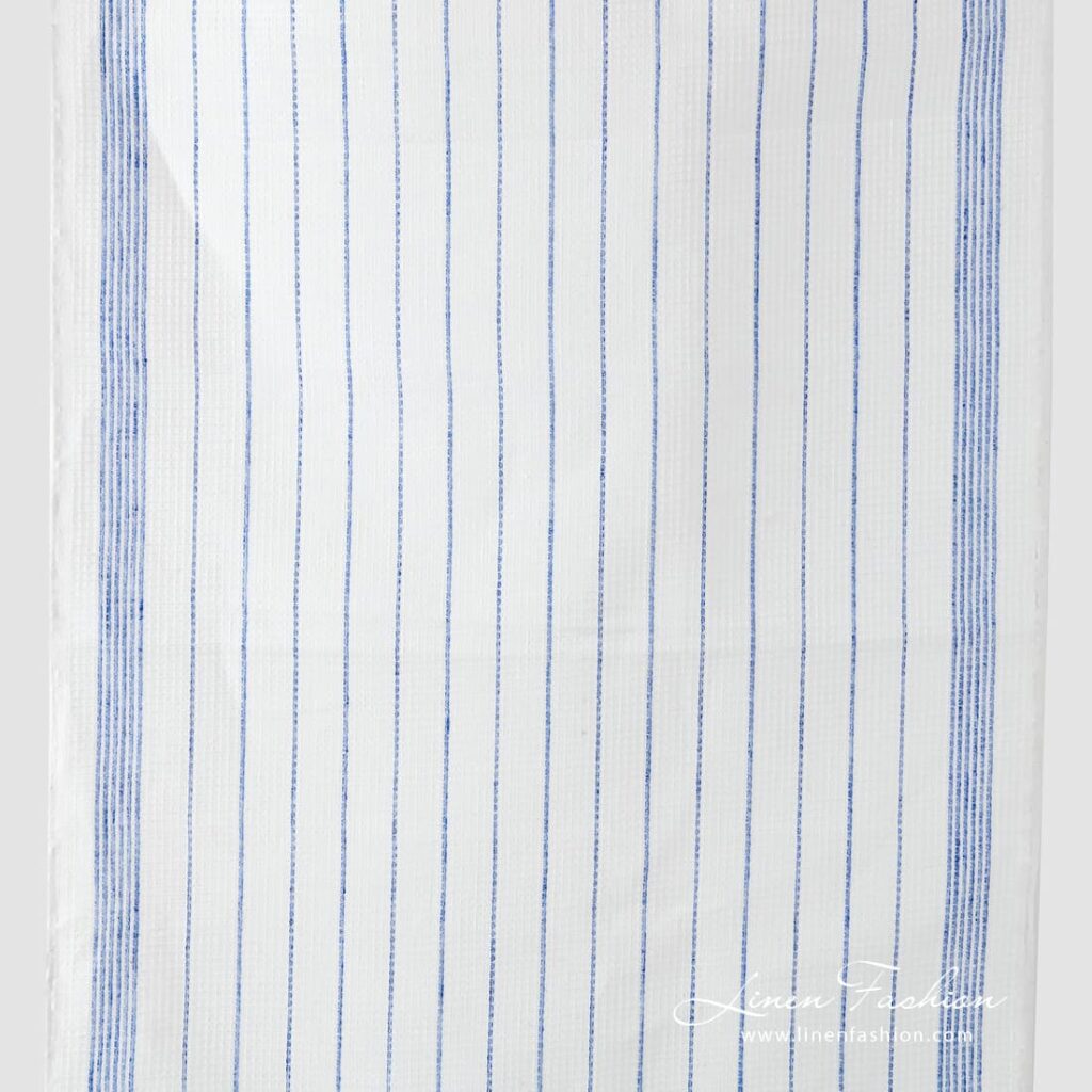 Narrow off white linen fabric with blue stripes.