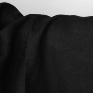 Washed linen fabric solid black colour close up view