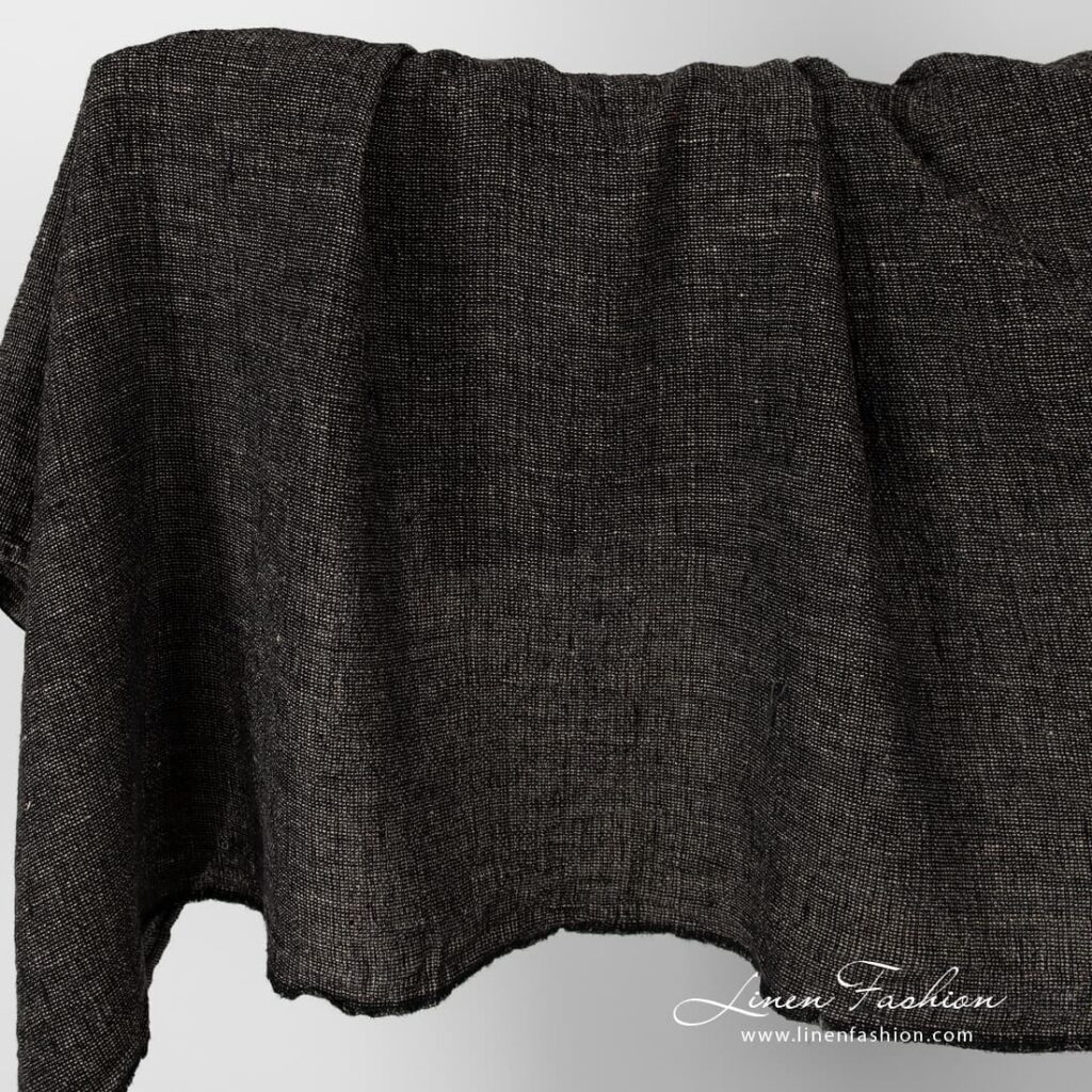 Linen fabric in black and flax melange, washed.