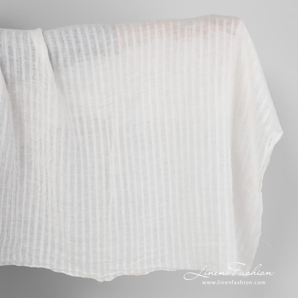 Washed off white striped linen fabric.