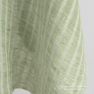 Green linen fabric in transparent vertical stripes