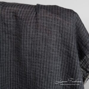 Dark grey linen fabric in transparent checks, specially washed to increase softness