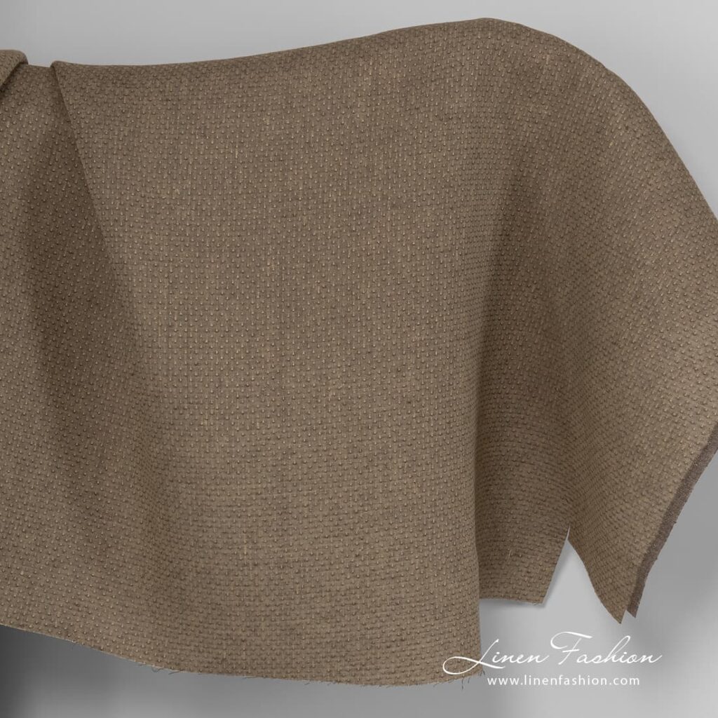 Brown melange linen fabric with spots.